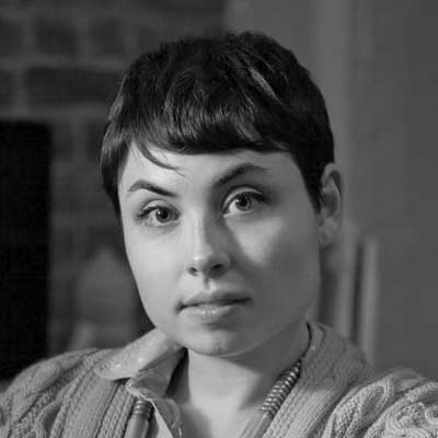 A black and white portrait photo of Elana Schlenker.